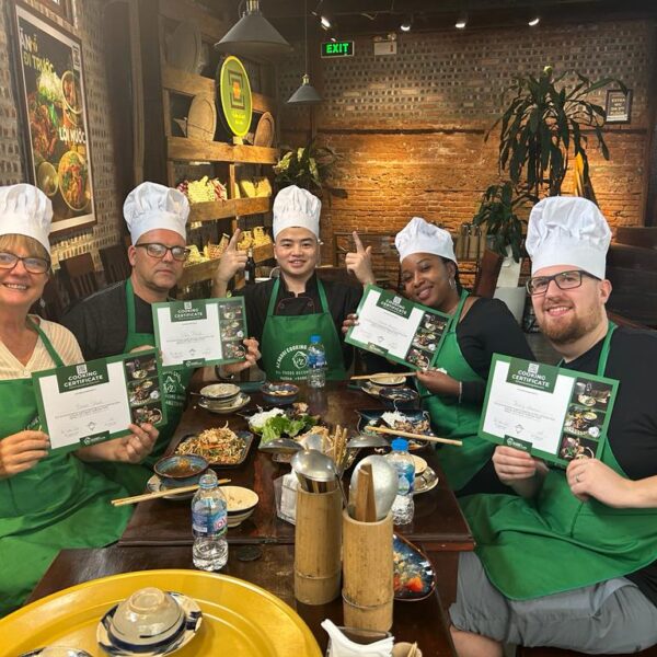 Guests taking a photo with the chef after the cooking session.