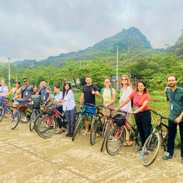 Travelers cycling through rice fields and rural villages in Ninh Binh